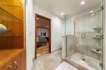 Experience luxury in this master bathroom featuring a spacious glass-enclosed shower with elegant tile work and a modern showerhead.