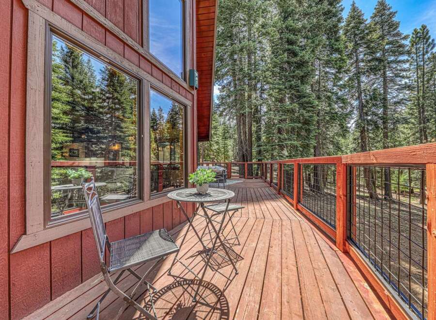 Enjoy the serene mountain setting from this charming wooden deck, perfect for outdoor relaxation.