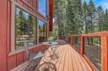 Enjoy the serene mountain setting from this charming wooden deck, perfect for outdoor relaxation.