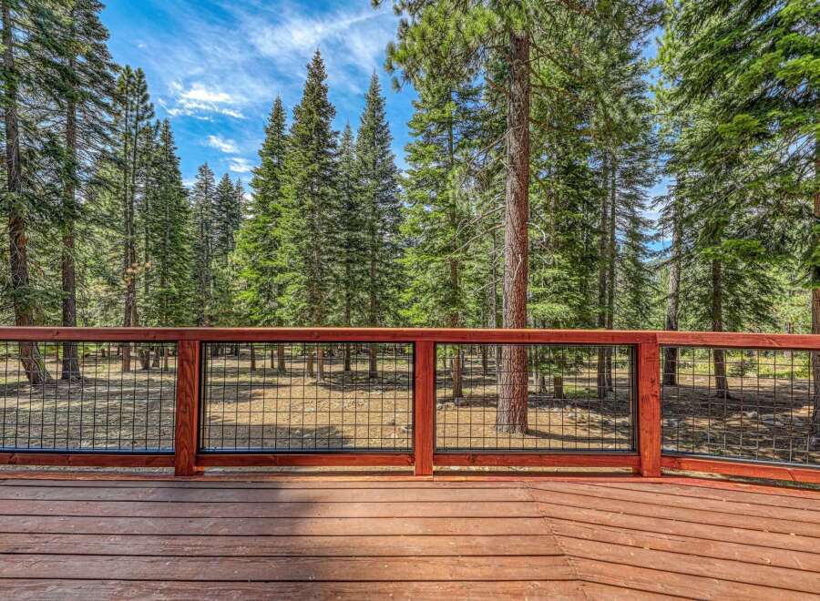 Enjoy the serene mountain views from this beautiful wooden deck, perfect for outdoor living.