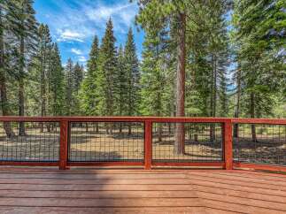 Enjoy the serene mountain views from this beautiful wooden deck, perfect for outdoor living.
