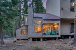 Nestled amongst tall pine trees, this charming home offers a serene mountain retreat.
