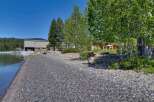 Enjoy lakeside living with this stunning property featuring a private pebble beach perfect for launching kayaks or simply relaxing by the water.