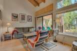 Experience cozy living in this charming mountain retreat, featuring a spacious living area with a comfortable sofa and accent chairs perfect for relaxing.