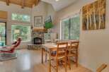 Experience cozy living in this charming mountain retreat, featuring a stunning stone fireplace and large windows that flood the space with natural light.