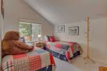This charming bedroom features two cozy twin beds, perfect for guests or children.