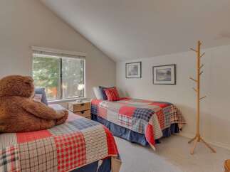 This charming bedroom features two cozy twin beds, perfect for guests or children.
