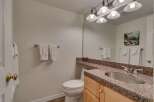 This bathroom features a clean and functional design with a white toilet and a vanity with a granite countertop.