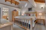 Experience rustic charm in this inviting bedroom featuring a sturdy log bed and a spacious wooden wardrobe.