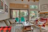Cozy living room with a plush sofa and a rustic coffee table, perfect for relaxing after a day of outdoor adventures.