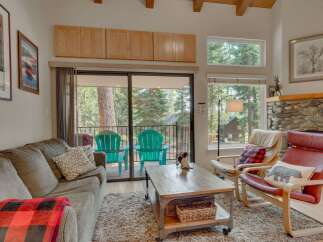 Cozy living room with a plush sofa and a rustic coffee table, perfect for relaxing after a day of outdoor adventures.