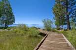Enjoy breathtaking lake views from this charming property featuring a scenic wooden boardwalk leading to the water's edge.