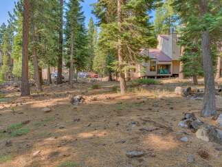 Nestled amidst tall pine trees, this property offers a serene mountain retreat.