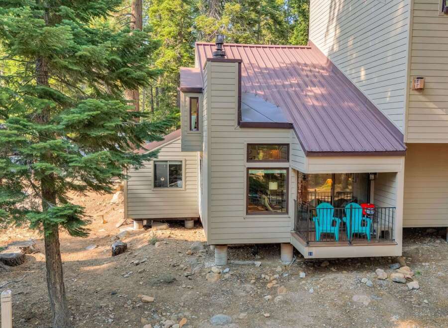 Nestled amongst tall pine trees, this charming home offers a serene mountain retreat.