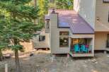 Nestled amongst tall pine trees, this charming home offers a serene mountain retreat.