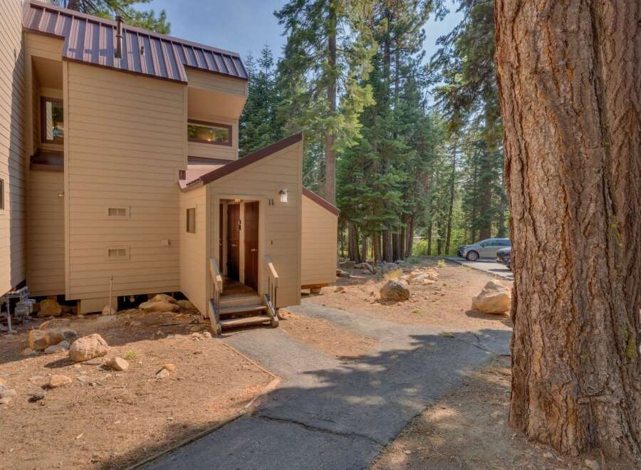 Nestled amidst tall pine trees, this charming property offers a serene mountain retreat.