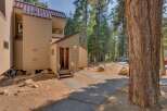 Nestled amidst tall pine trees, this charming property offers a serene mountain retreat.