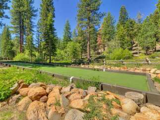 Enjoy outdoor recreation with this beautifully maintained bocce ball court, nestled amidst a serene forest setting.