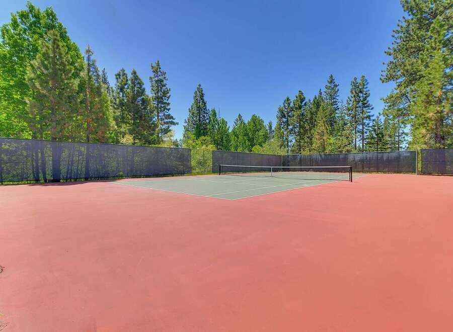 Enjoy outdoor recreation on this pristine tennis court, perfect for a friendly match or practice.
