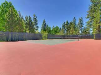 Enjoy outdoor recreation on this pristine tennis court, perfect for a friendly match or practice.