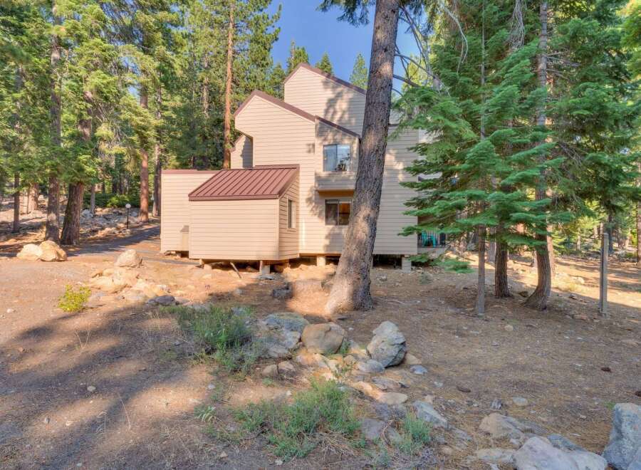 Nestled amidst tall pine trees, this multi-story home offers a serene mountain retreat.