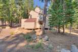 Nestled amidst tall pine trees, this multi-story home offers a serene mountain retreat.