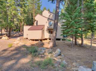 Nestled amidst tall pine trees, this multi-story home offers a serene mountain retreat.