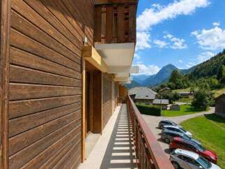 Experience the charm of mountain living with this stunning wooden chalet, featuring a spacious balcony offering breathtaking views of the surrounding alpine landscape.