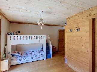 This charming room features a cozy bunk bed, perfect for children or guests, with a playful bedding set.
