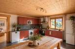 Experience rustic charm in this beautifully appointed kitchen, featuring warm wooden ceilings and cabinetry.