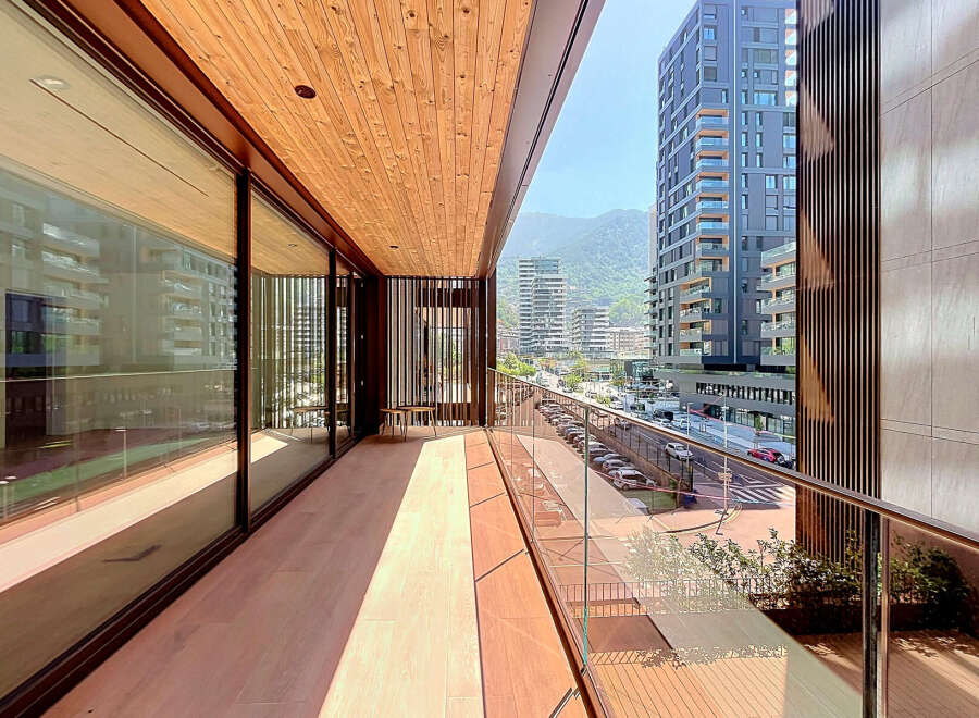 Experience modern living on this spacious balcony with stunning city and mountain views.