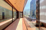 Experience modern living on this spacious balcony with stunning city and mountain views.