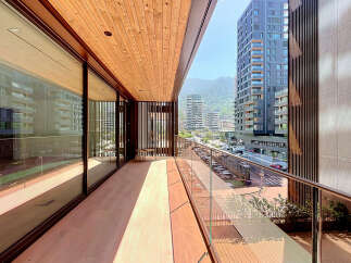 Experience modern living on this spacious balcony with stunning city and mountain views.