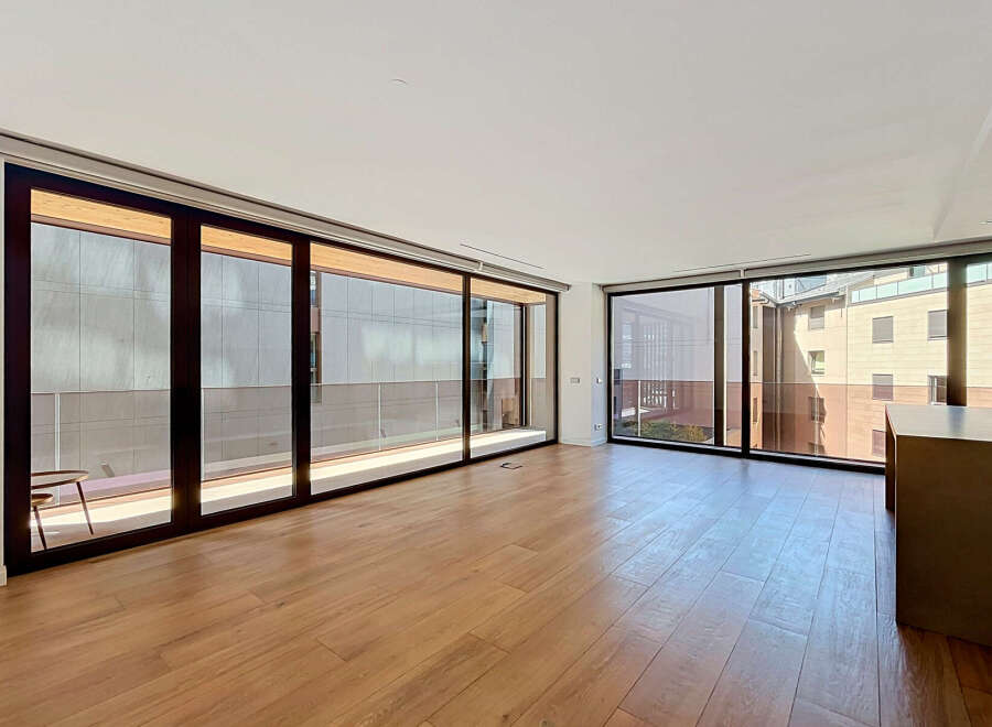 Experience modern living in this spacious apartment featuring floor-to-ceiling windows that flood the open-concept living area with natural light.