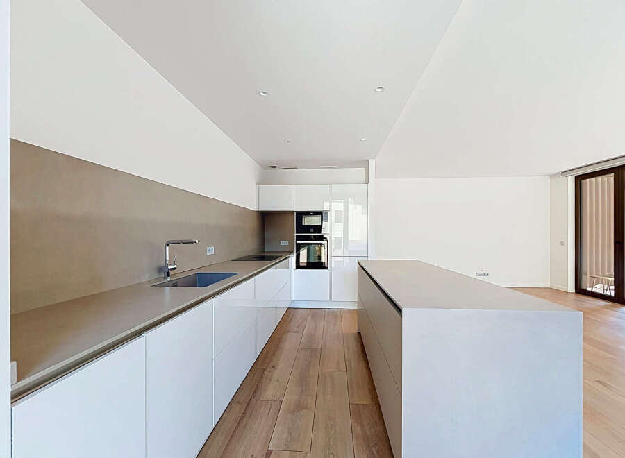 Experience modern living in this sleek, contemporary kitchen featuring a spacious island and ample counter space.