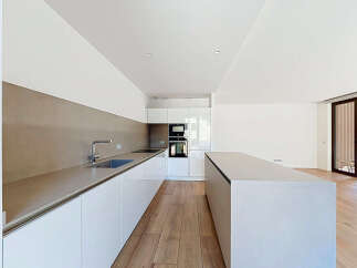 Experience modern living in this sleek, contemporary kitchen featuring a spacious island and ample counter space.