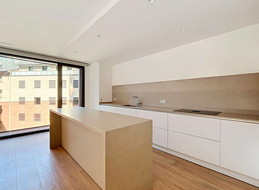 Experience modern living in this stunning kitchen featuring a sleek island and ample counter space.