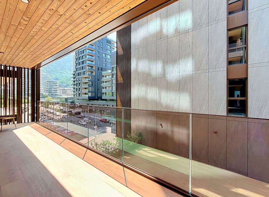 Experience modern living with this stunning balcony offering breathtaking city and mountain views.