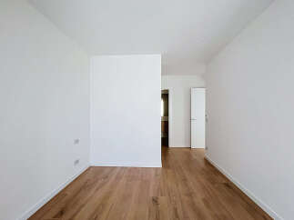 Step into this bright and airy space featuring pristine white walls and a beautiful wooden floor.