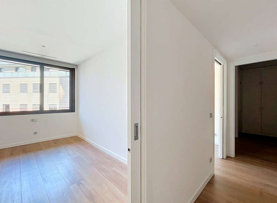 Step into this bright and airy room featuring a large window that floods the space with natural light.