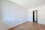 Step into this bright and airy room, featuring pristine white walls and elegant wooden flooring that exudes warmth and sophistication.