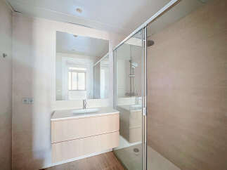 Experience modern comfort in this beautifully appointed bathroom, featuring a sleek vanity with ample storage and a spacious walk-in shower with a rainfall showerhead.