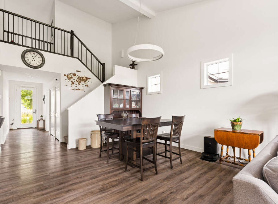 This spacious dining area features a large dark wood table with chairs, complemented by a traditional china cabinet.
