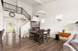 This spacious dining area features a large dark wood table with chairs, complemented by a traditional china cabinet.
