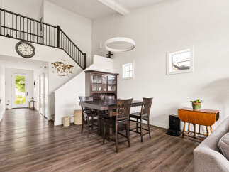 This spacious dining area features a large dark wood table with chairs, complemented by a traditional china cabinet.