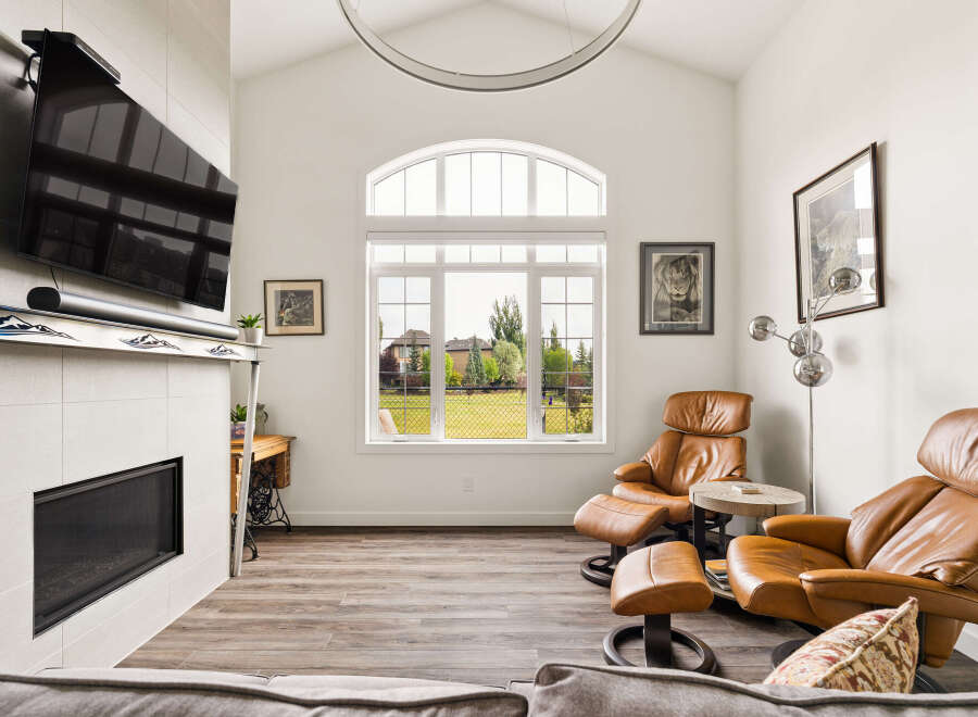 Experience modern living in this spacious living room, featuring a sleek fireplace and a mounted television for ultimate entertainment.
