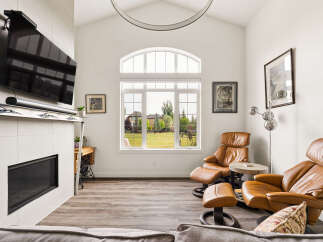 Experience modern living in this spacious living room, featuring a sleek fireplace and a mounted television for ultimate entertainment.