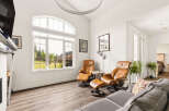 Experience luxury living in this spacious living room, featuring comfortable leather recliners and a large sectional sofa perfect for gatherings.