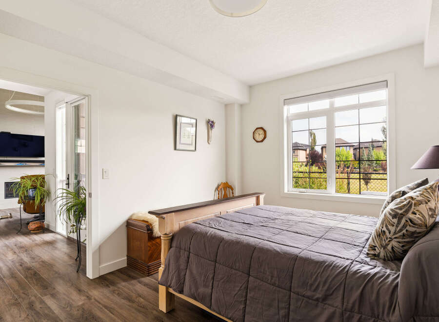 This inviting bedroom features a comfortable bed with a plush comforter and decorative pillows, perfect for relaxation.