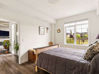 This inviting bedroom features a comfortable bed with a plush comforter and decorative pillows, perfect for relaxation.